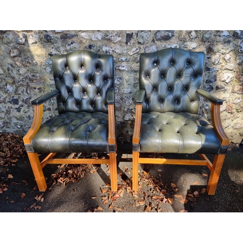 1108 - A pair of reproduction green buttoned leather and beech Gainsborough chairs.