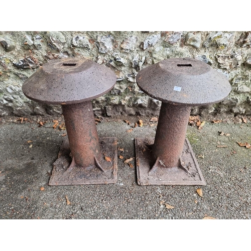 1113 - An unusual pair of cast iron staddle stones, 56cm high, (top of one cracked).