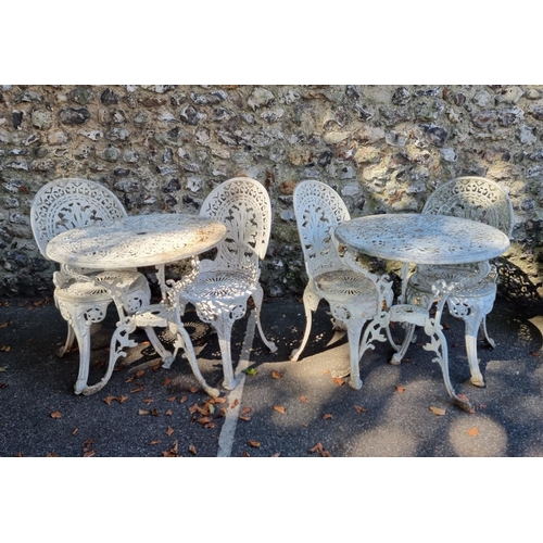 1117 - Two white painted aluminium circular garden tables and four chairs, the table 69cm diameter.... 