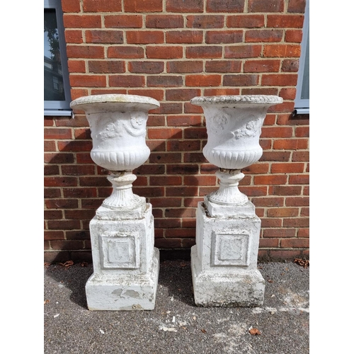 1120 - A pair of white painted composition stone Campana urns and pedestals, 109cm high.