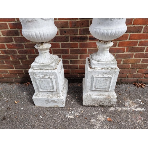 1120 - A pair of white painted composition stone Campana urns and pedestals, 109cm high.