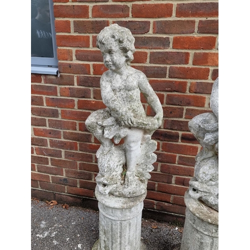 1121 - A pair of old painted and weathered composition stone cherub and dolphin figures, on pedestals, 128c... 