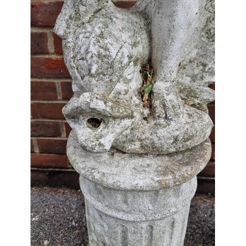 1121 - A pair of old painted and weathered composition stone cherub and dolphin figures, on pedestals, 128c... 