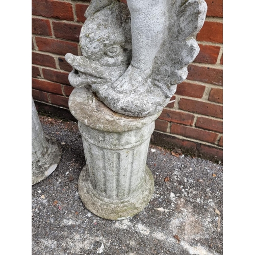 1121 - A pair of old painted and weathered composition stone cherub and dolphin figures, on pedestals, 128c... 