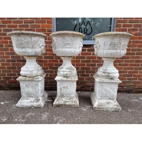 1122 - A large set of three white painted and weathered composition stone Campana urns and pedestals, ... 