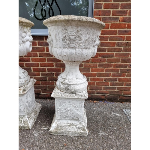 1122 - A large set of three white painted and weathered composition stone Campana urns and pedestals, ... 