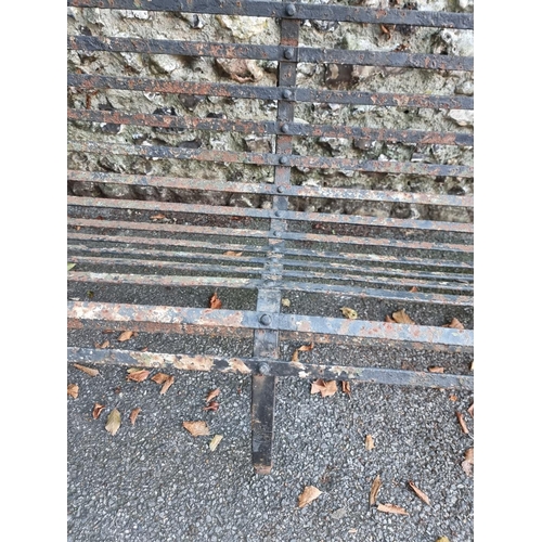 1127 - A large wrought iron garden bench, 243cm wide. 