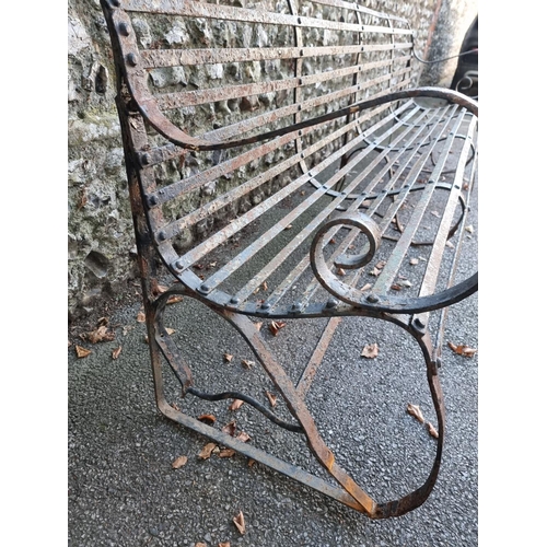 1127 - A large wrought iron garden bench, 243cm wide. 