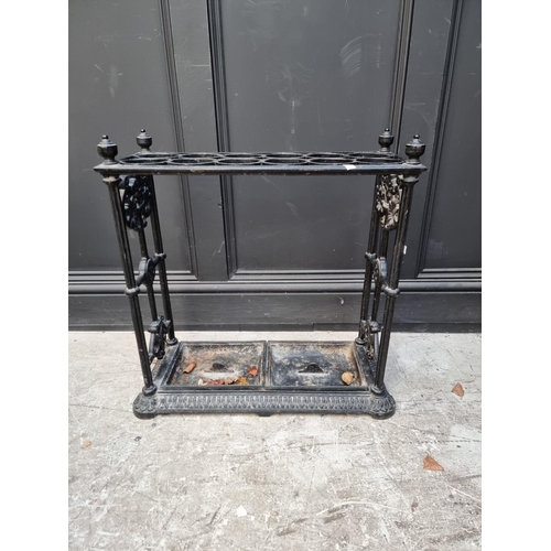 1133 - A large old cast iron stick stand, 63cm wide.