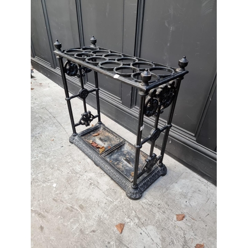 1133 - A large old cast iron stick stand, 63cm wide.