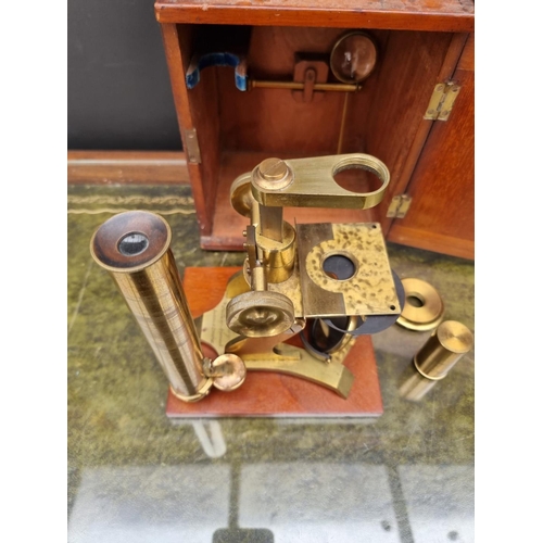 1162 - An antique brass microscope, by Stanley, in mahogany case.  