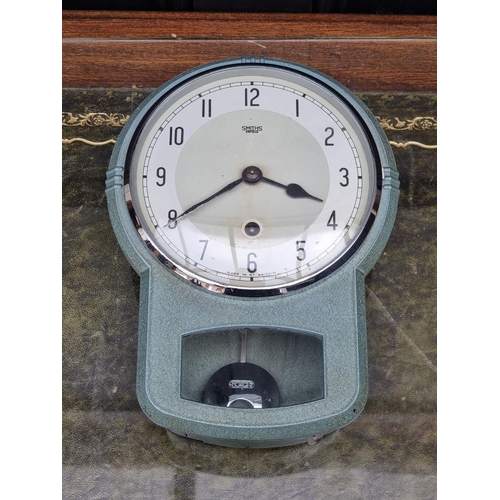 1173 - A vintage green painted metal drop dial timepiece, by Smiths, 25.5cm high, with pendulum. ... 