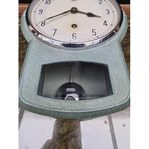 1173 - A vintage green painted metal drop dial timepiece, by Smiths, 25.5cm high, with pendulum. ... 