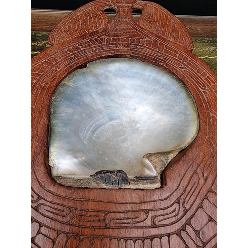 1175 - Ethnographica: a tribal carved wood and oyster shell dish, 38.5cm long. 