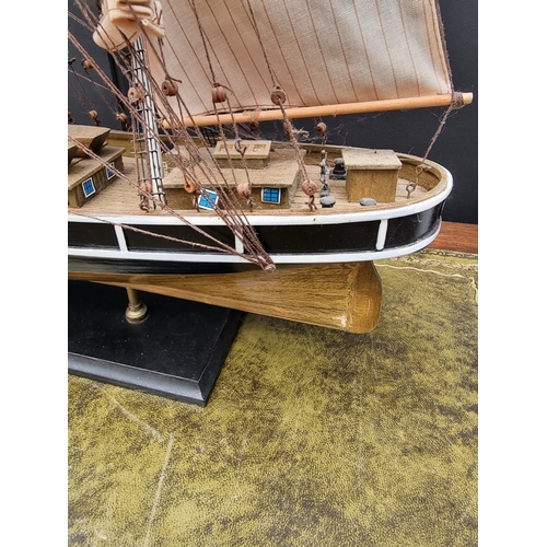 1200 - A painted wood model of The Cutty Sark, total length 88cm.