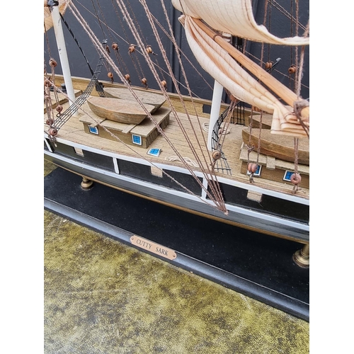 1200 - A painted wood model of The Cutty Sark, total length 88cm.