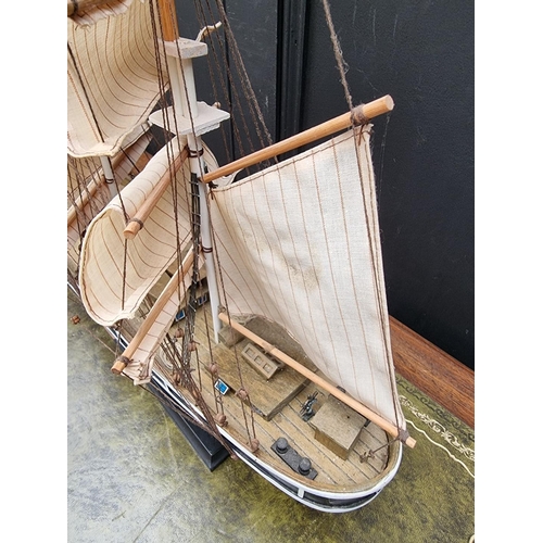 1200 - A painted wood model of The Cutty Sark, total length 88cm.