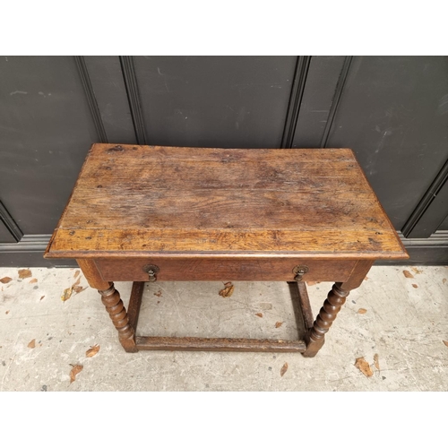 1041 - A late 17th century oak single drawer side table, 82.5cm wide. 