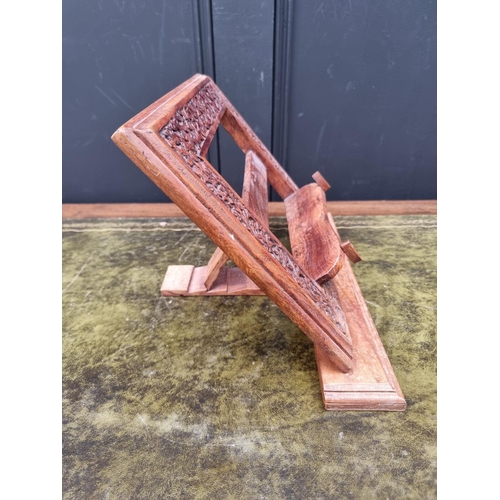 1049 - An Eastern carved hardwood folding easel back prayer book stand, 36cm wide.