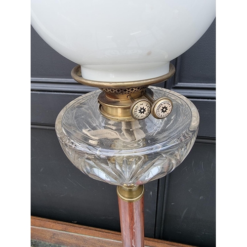 1057 - A red marble and brass mounted oil lamp, height excluding chimney 79.5cm.  ... 