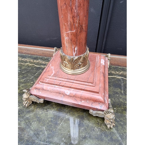 1057 - A red marble and brass mounted oil lamp, height excluding chimney 79.5cm.  ... 