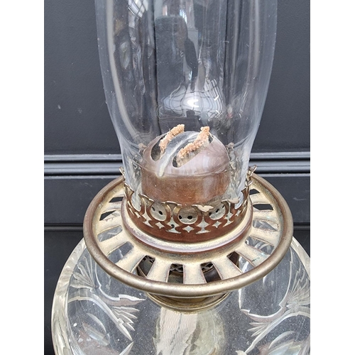 1057 - A red marble and brass mounted oil lamp, height excluding chimney 79.5cm.  ... 