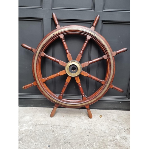 1336 - A large antique teak and brass ship's wheel, 136.5cm diameter, (repairs). ... 