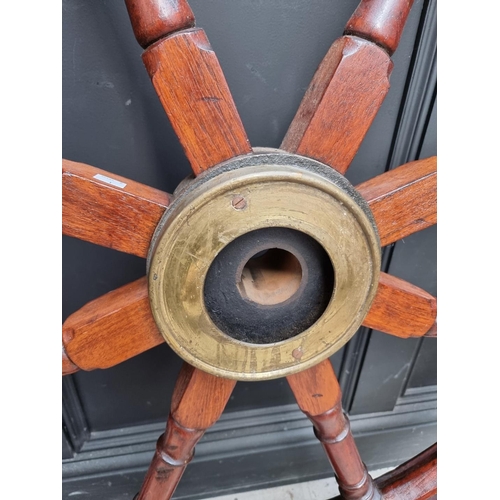 1336 - A large antique teak and brass ship's wheel, 136.5cm diameter, (repairs). ... 