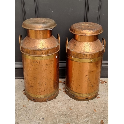 1344 - A near pair of copper milk churns and covers, largest 72cm high.