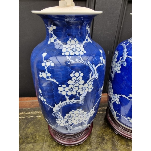 1383 - A pair of Chinese blue and white pottery adjustable table lamps, height excluding fitting 31cm. ... 