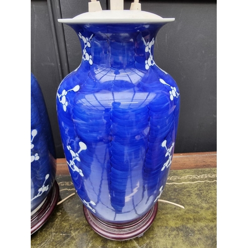 1383 - A pair of Chinese blue and white pottery adjustable table lamps, height excluding fitting 31cm. ... 