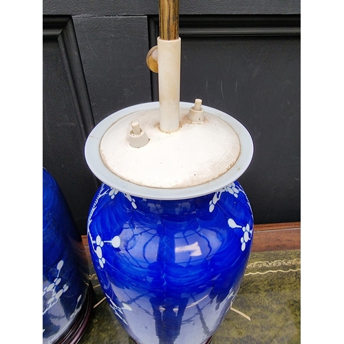 1383 - A pair of Chinese blue and white pottery adjustable table lamps, height excluding fitting 31cm. ... 