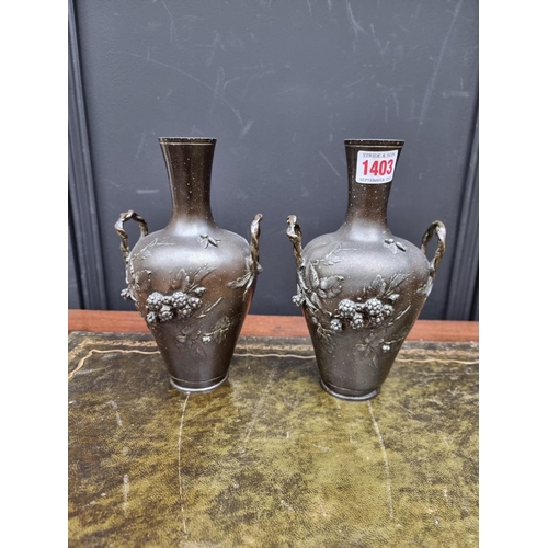 1403 - A pair of cast metal twin handled vases, signed Francois Moreau, 21cm high. 