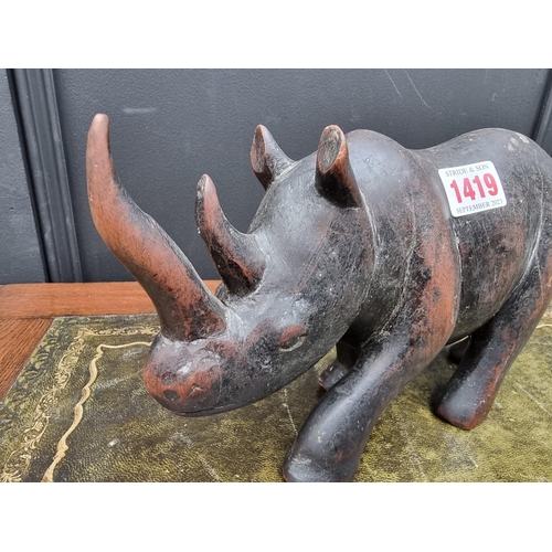 1419 - An African carved hardwood rhinoceros, 26cm long.... 