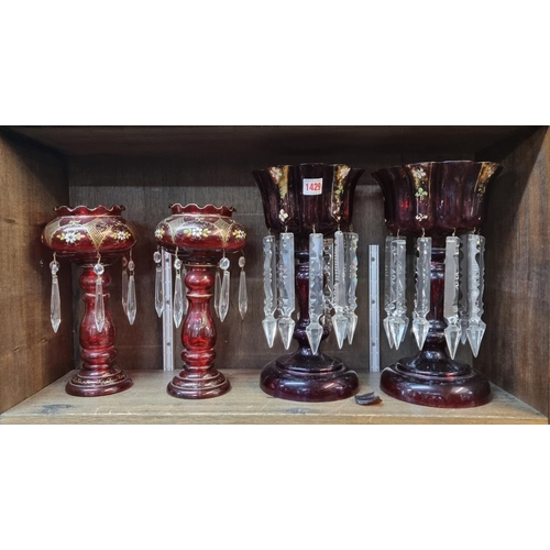 1429 - A pair of cranberry stained glass lustres, 28.5cm high; together with another pair of ruby glass exa... 