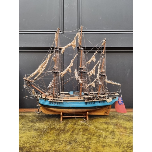 1442 - A painted wood model of 'The Bounty', 50cm long, on wood stand. 