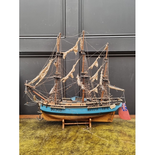 1442 - A painted wood model of 'The Bounty', 50cm long, on wood stand. 