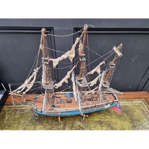 1442 - A painted wood model of 'The Bounty', 50cm long, on wood stand. 