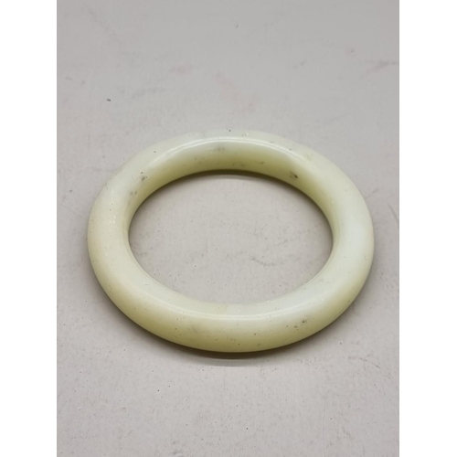 1462 - A Chinese celadon jade bangle, 9cm diameter.