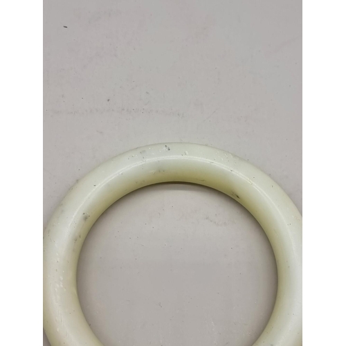 1462 - A Chinese celadon jade bangle, 9cm diameter.