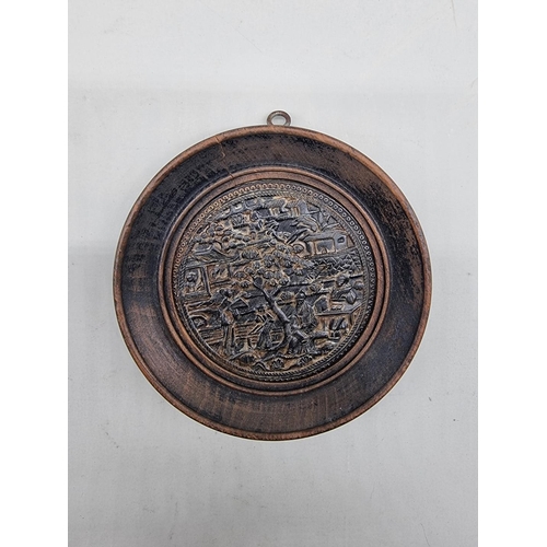 1466 - A Chinese pressed horn roundel, 9cm diameter, in ebonized frame. 