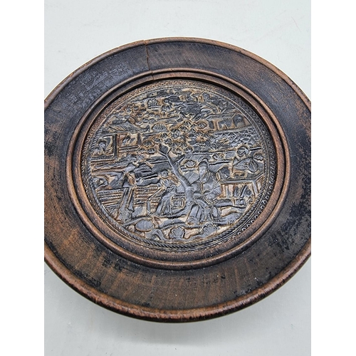 1466 - A Chinese pressed horn roundel, 9cm diameter, in ebonized frame. 