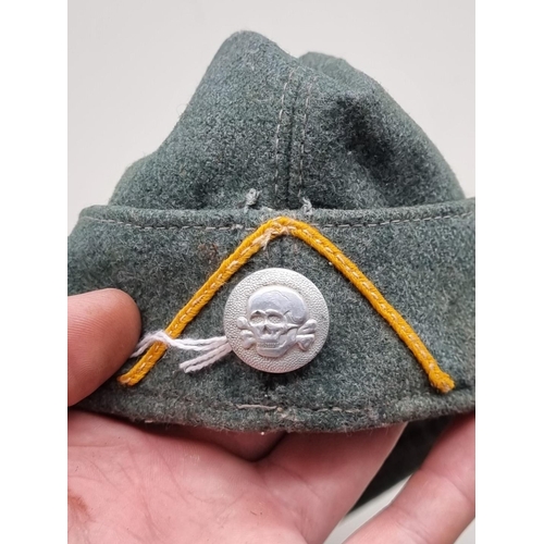 1537 - A German Third Reich M1934 Waffen-SS cavalry Forage cap, with aluminium button, marked 'SS RSM', wit... 