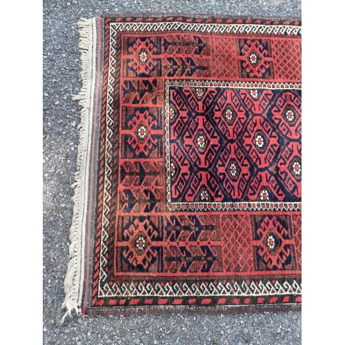 1128 - A small Turkoman rug, having geometric borders, on a red and blue ground, 162 x 88cm.... 