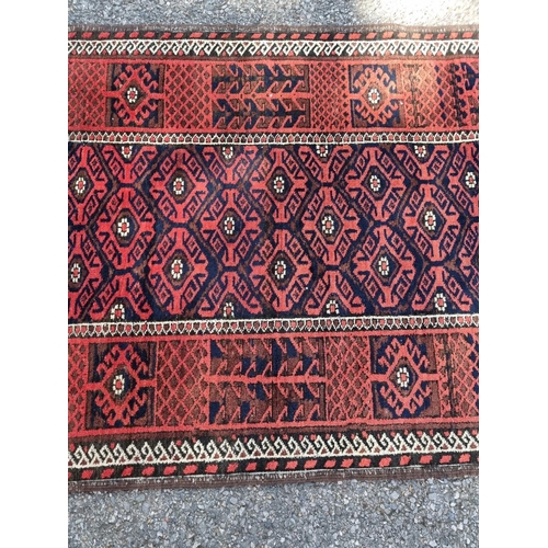 1128 - A small Turkoman rug, having geometric borders, on a red and blue ground, 162 x 88cm.... 