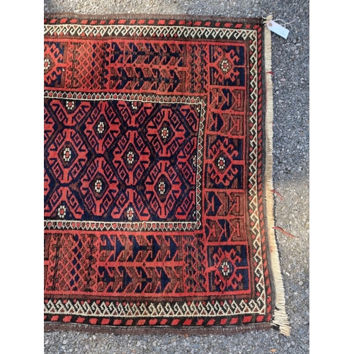 1128 - A small Turkoman rug, having geometric borders, on a red and blue ground, 162 x 88cm.... 