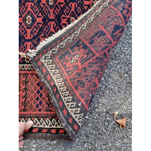 1128 - A small Turkoman rug, having geometric borders, on a red and blue ground, 162 x 88cm.... 