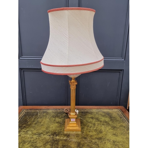 1059 - A gilt brass Corinthian column table lamp, (converted). 