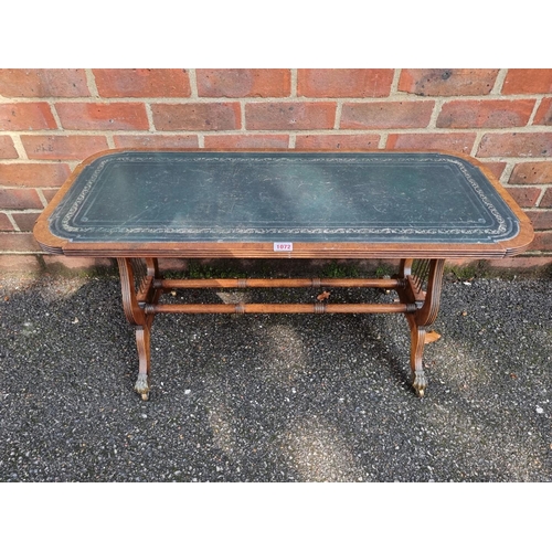 1072 - A reproduction mahogany and leather top low occasional table, 90cm wide.