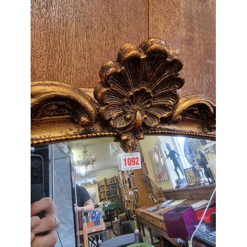 1092 - A large reproduction gilt framed overmantel mirror, 140 x 136cm. 